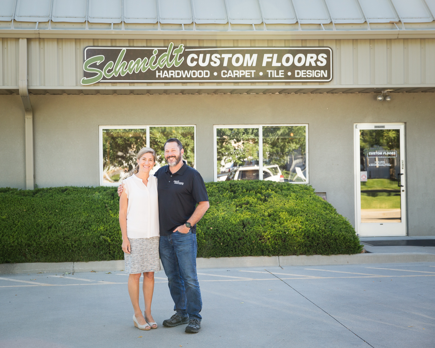 Barry and Alyssa Schmidt in front of the Schmidt Custom Floors Loveland office